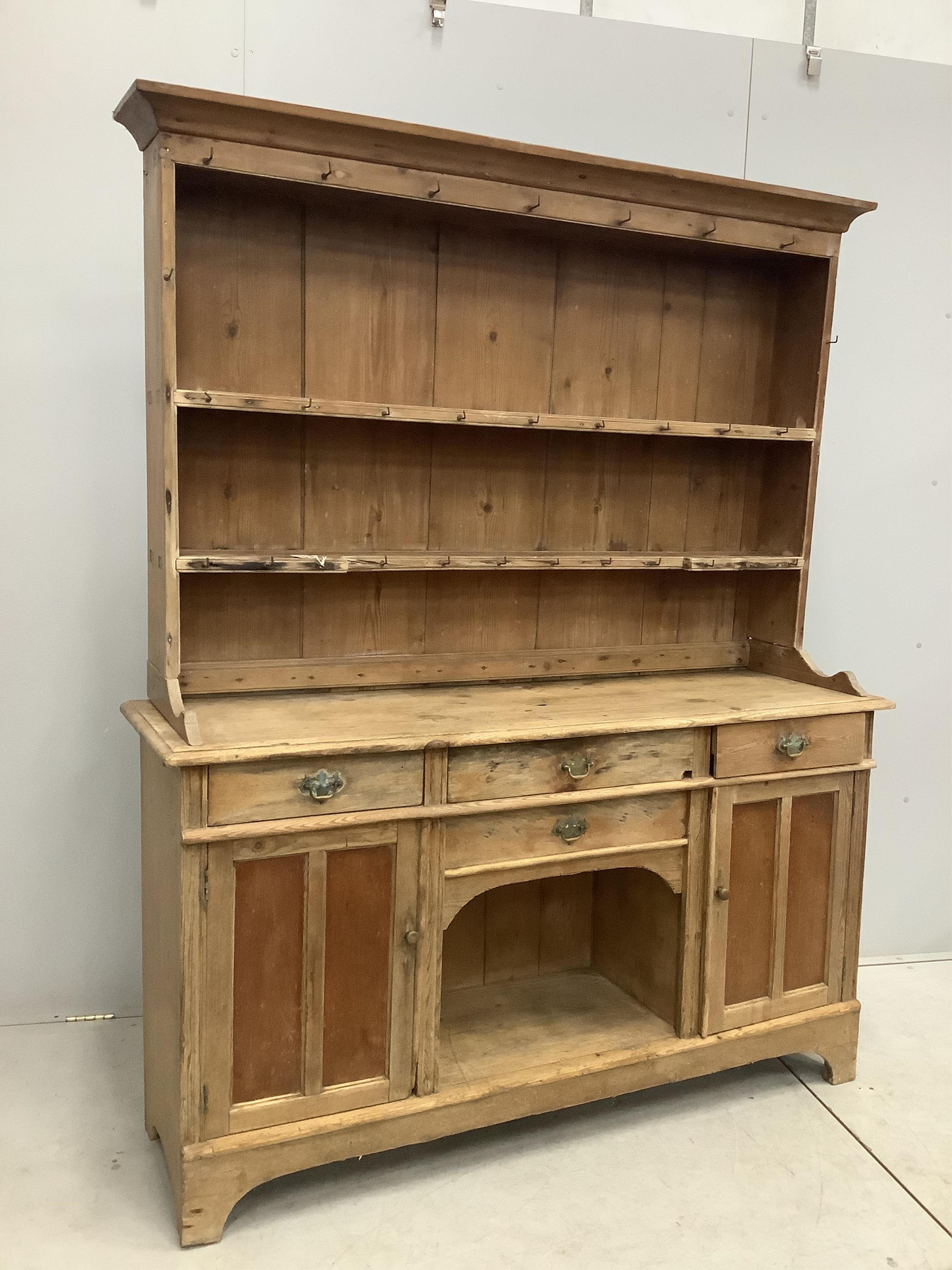 A 19th century and later pine dresser with boarded rack, width 154cm, depth 44cm, height 192cm. Condition - fair